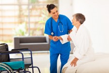 Caregiver helping senior via Shutterstock