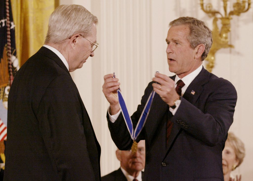 President George W. Bush presents D.A. Henderson, who is credited with eradicating smallpox worldwide, with the Presidential Medal of Freedom at the White House, July 9, 2002. REUTERS/Hyungwon Kang/File Photo